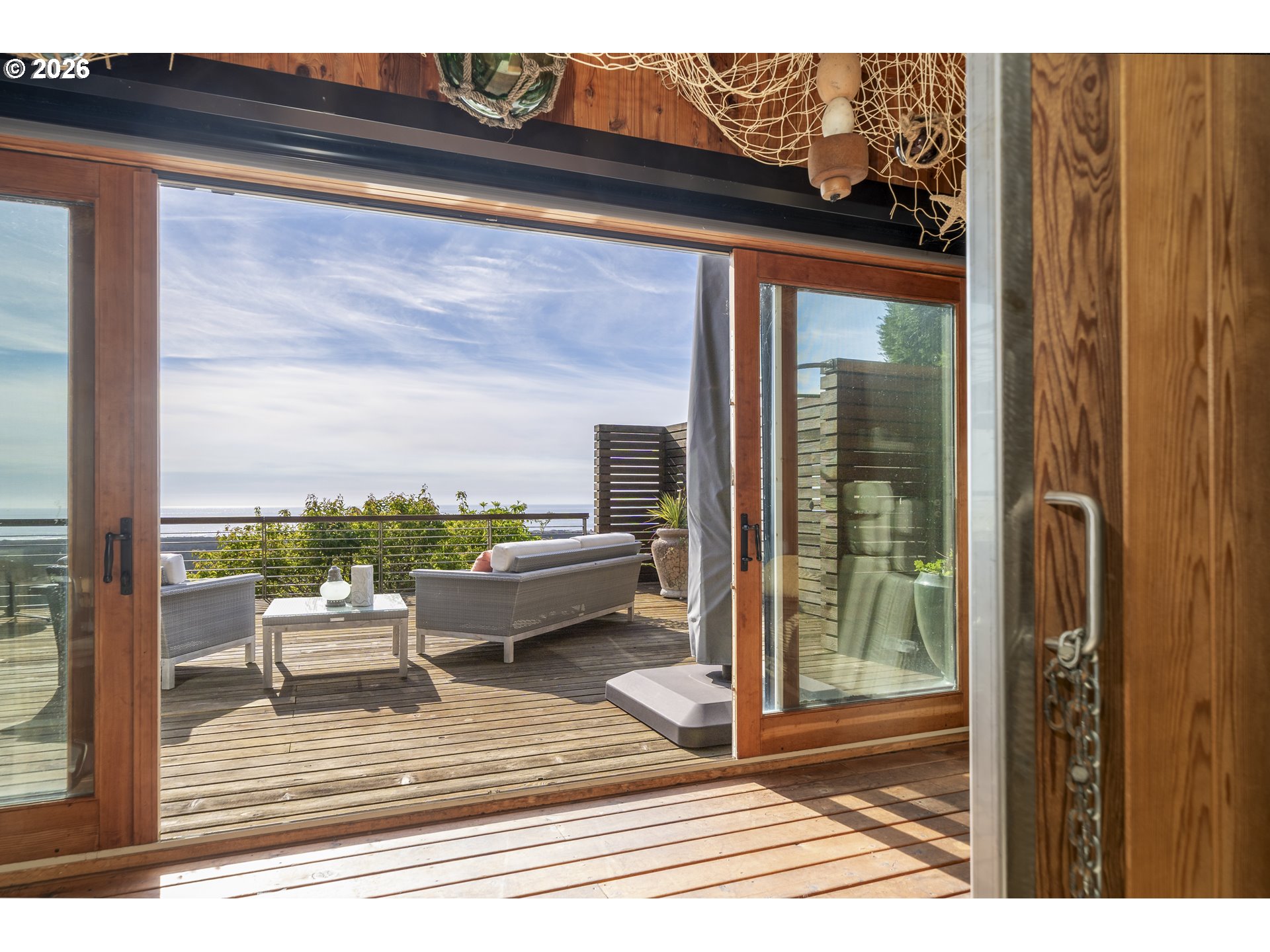7850 Brooten Mountain Road Pacific City, OR 97135 - Photo 42 of 48 a balcony with wooden floor and glass door