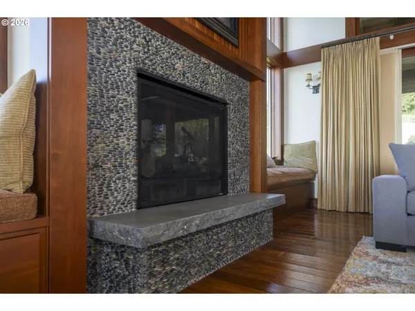 a living room with furniture a fireplace and a large window