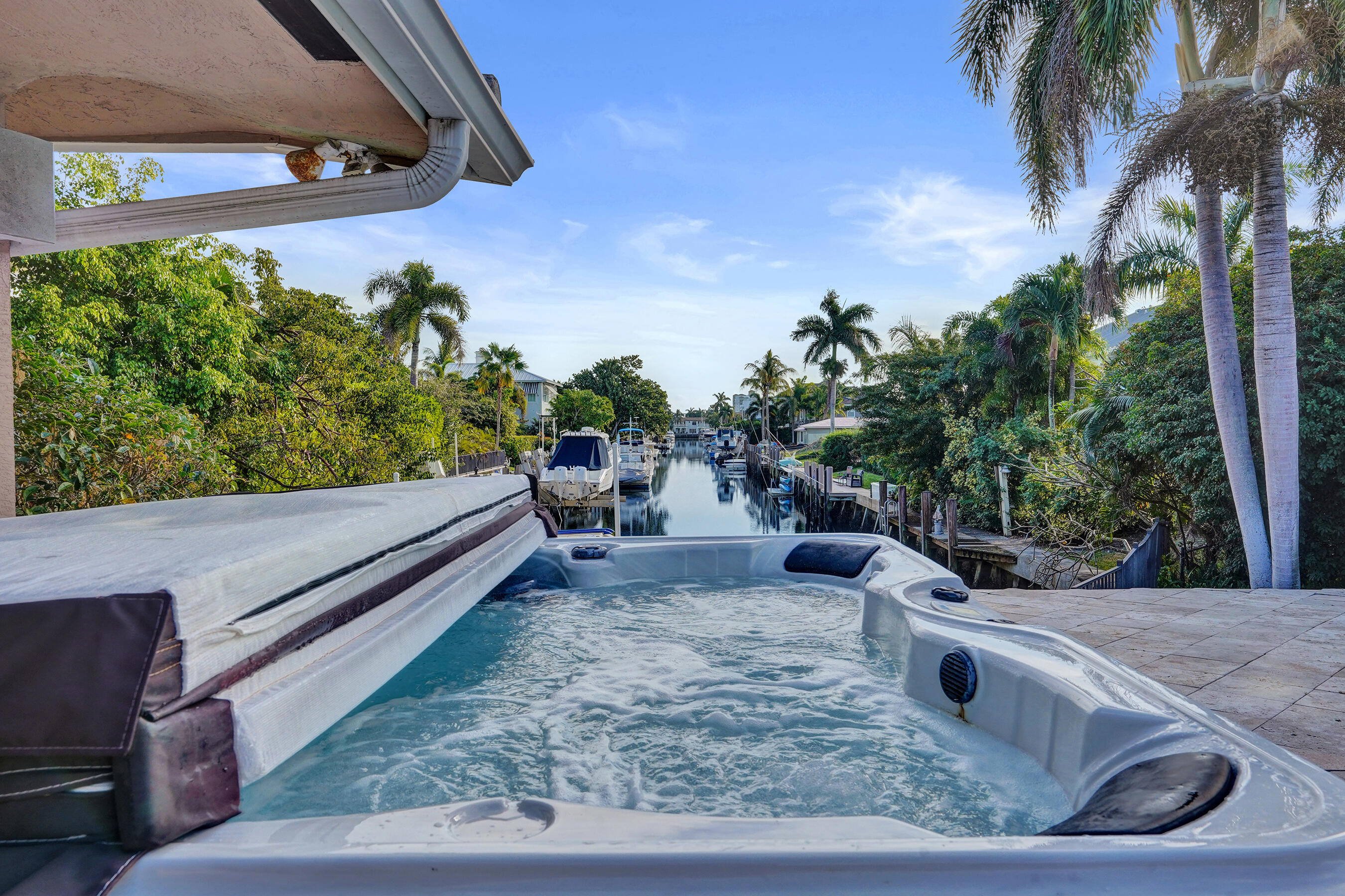 7050 Northeast 7th Avenue Boca Raton, FL 33487 - Photo 2 of 25 a view of a backyard with plants and a patio