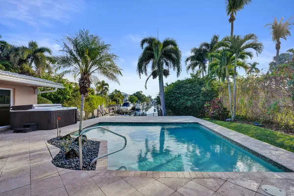 a view of a backyard with swimming pool