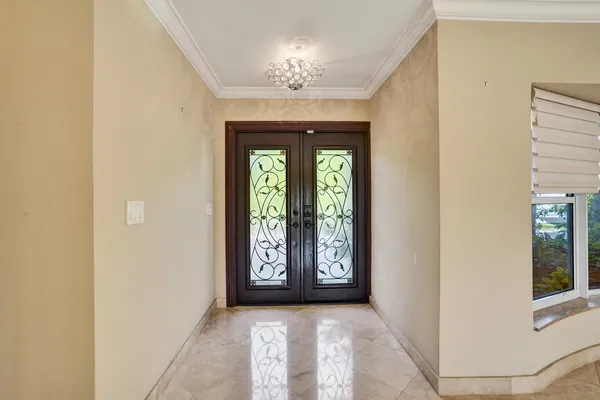 an empty room with windows and chandelier