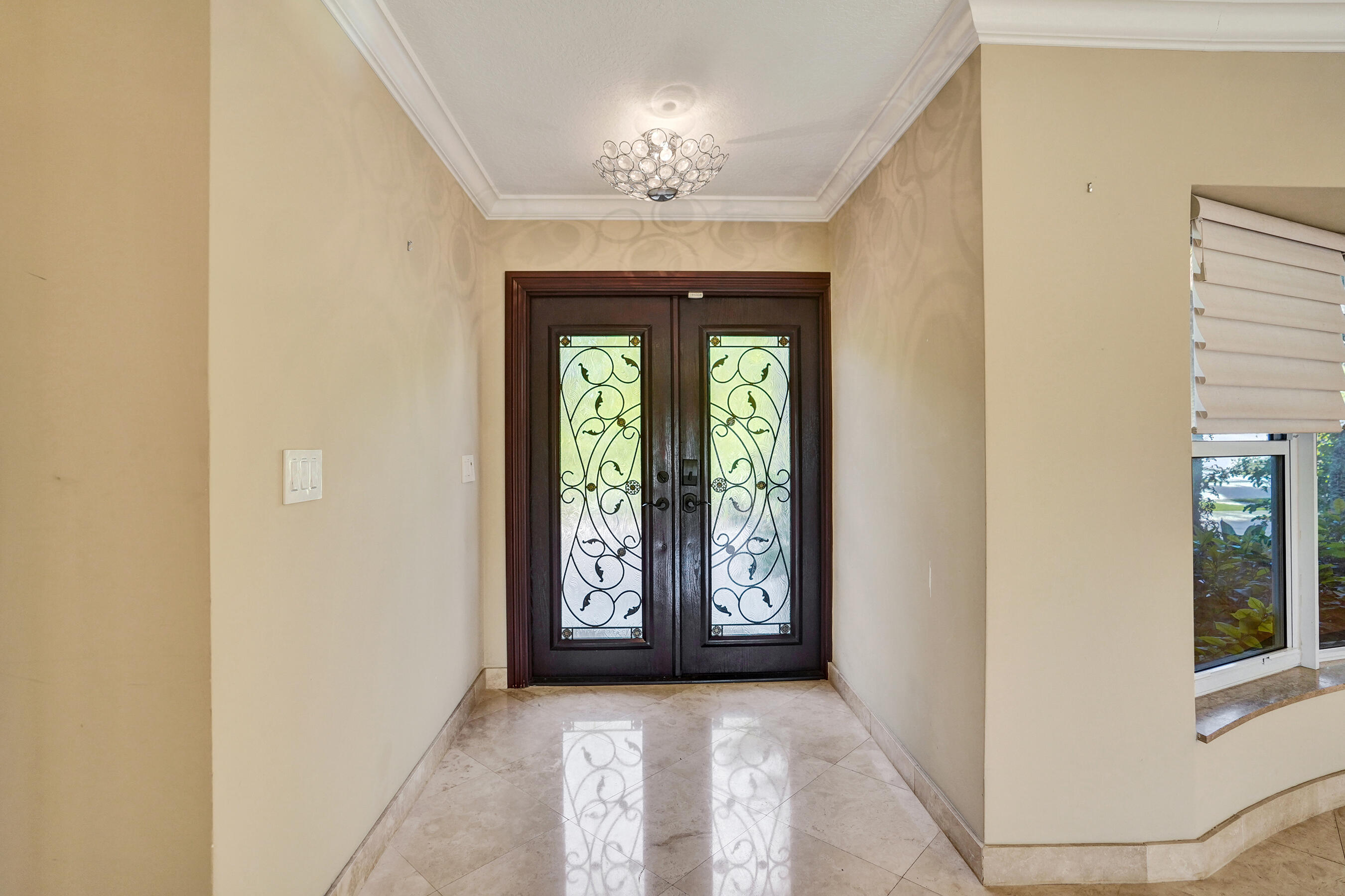 7050 Northeast 7th Avenue Boca Raton, FL 33487 - Photo 7 of 25 an empty room with windows and chandelier