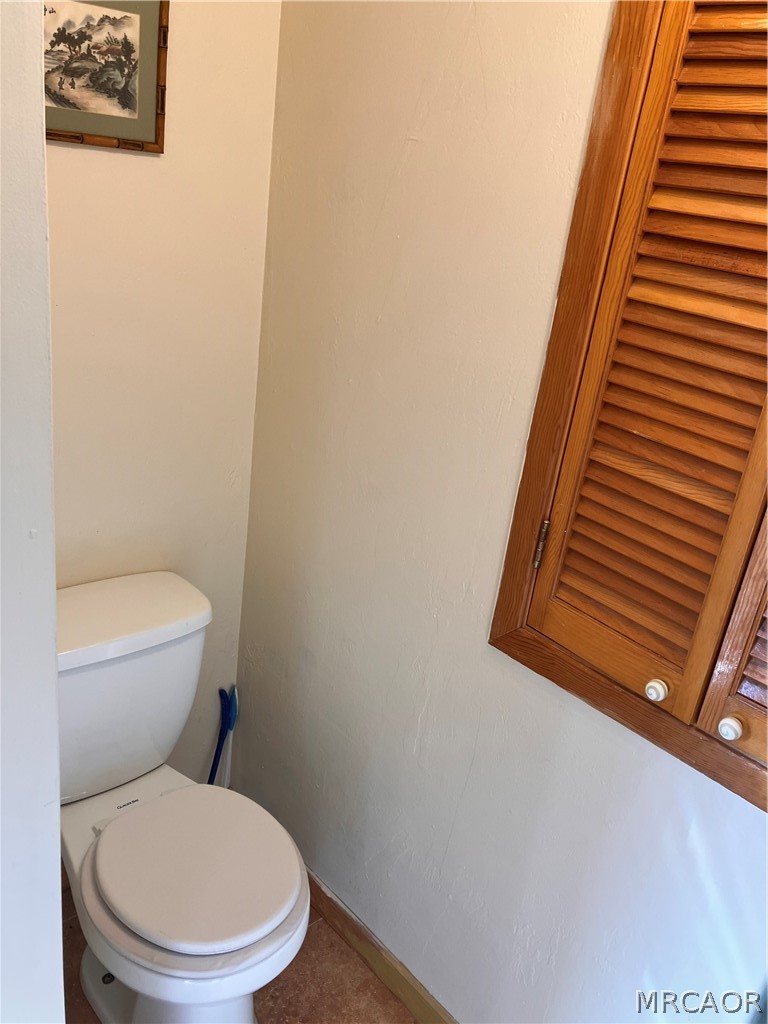 23228 Brookside Road Crestline, CA 92325 - Photo 19 of 23 a white toilet sitting next to a white wall