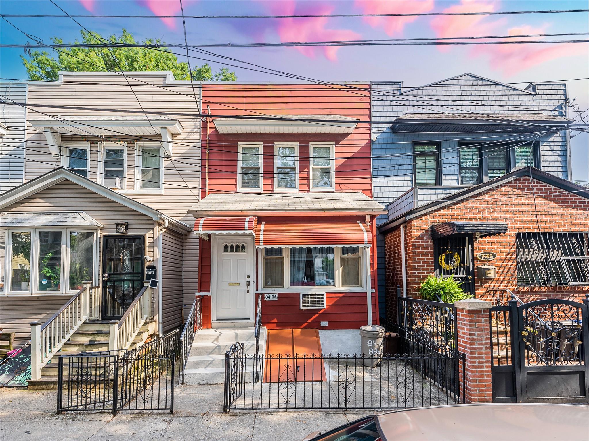 84-04 89th Avenue Queens, NY 11421 - Photo 1 of 1 View of property featuring entry steps, a fenced front yard, and a gate