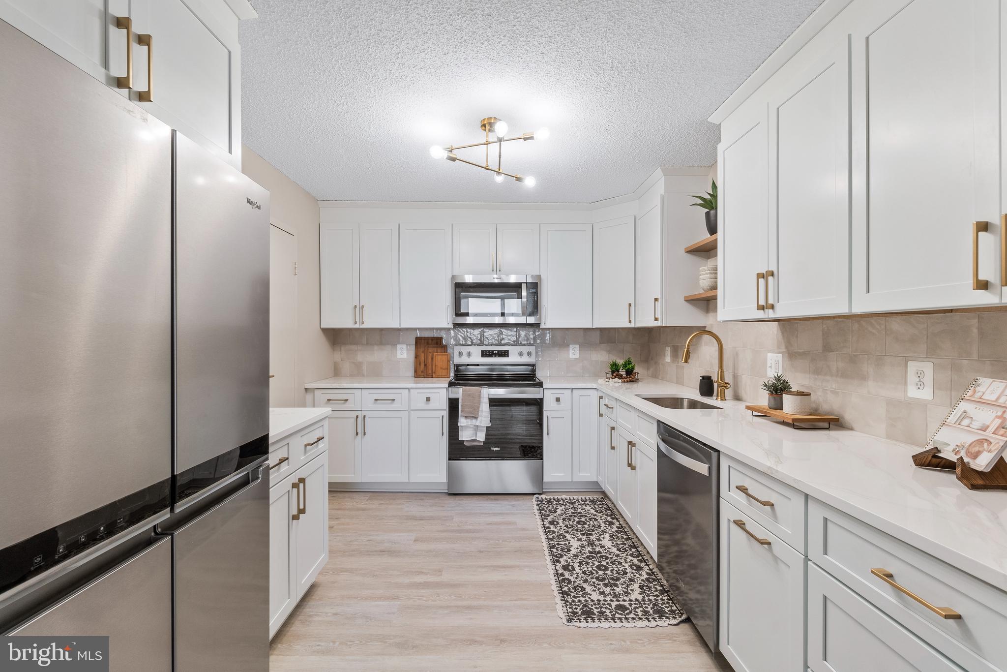 205 East Joppa Road, Unit 2703 Towson, MD 21286 - Photo 19 of 34 a kitchen with granite countertop white cabinets and white appliances