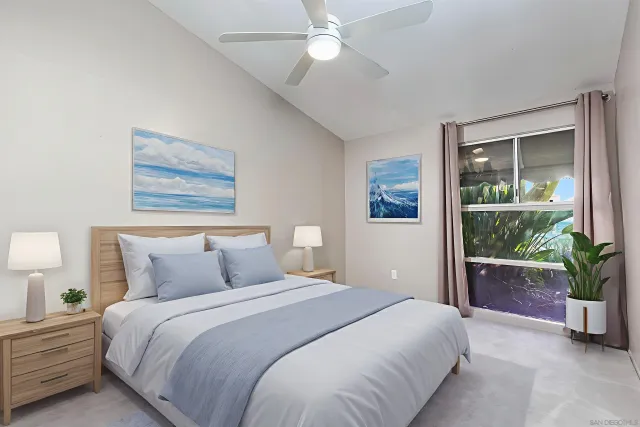 a bedroom with a large bed and a potted plant