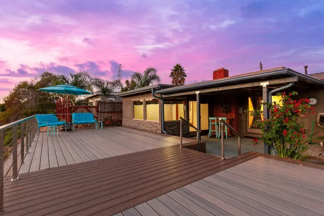 a view of a house with wooden deck
