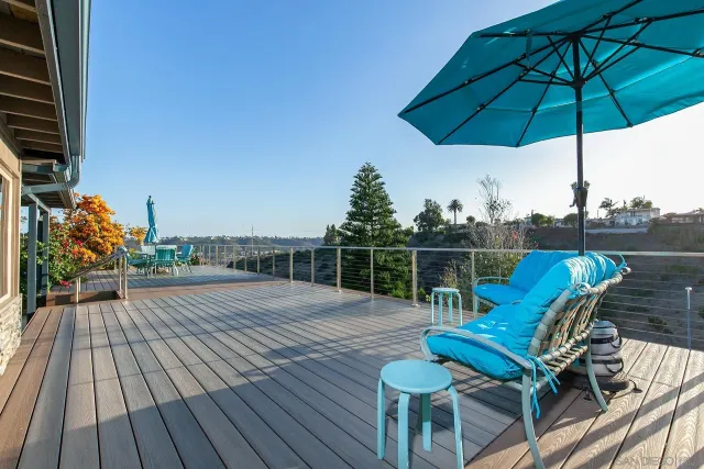 a view of a roof deck with chair and wooden floor