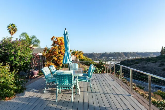 a view of a houses with cars park