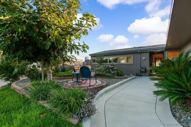 a view of a patio with table and chairs and potted plants