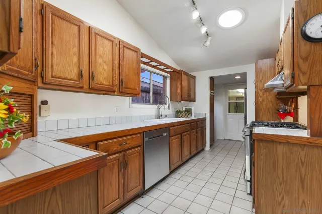 a kitchen with stainless steel appliances granite countertop a sink and cabinets