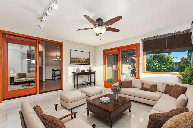 a living room with furniture a ceiling fan and a window