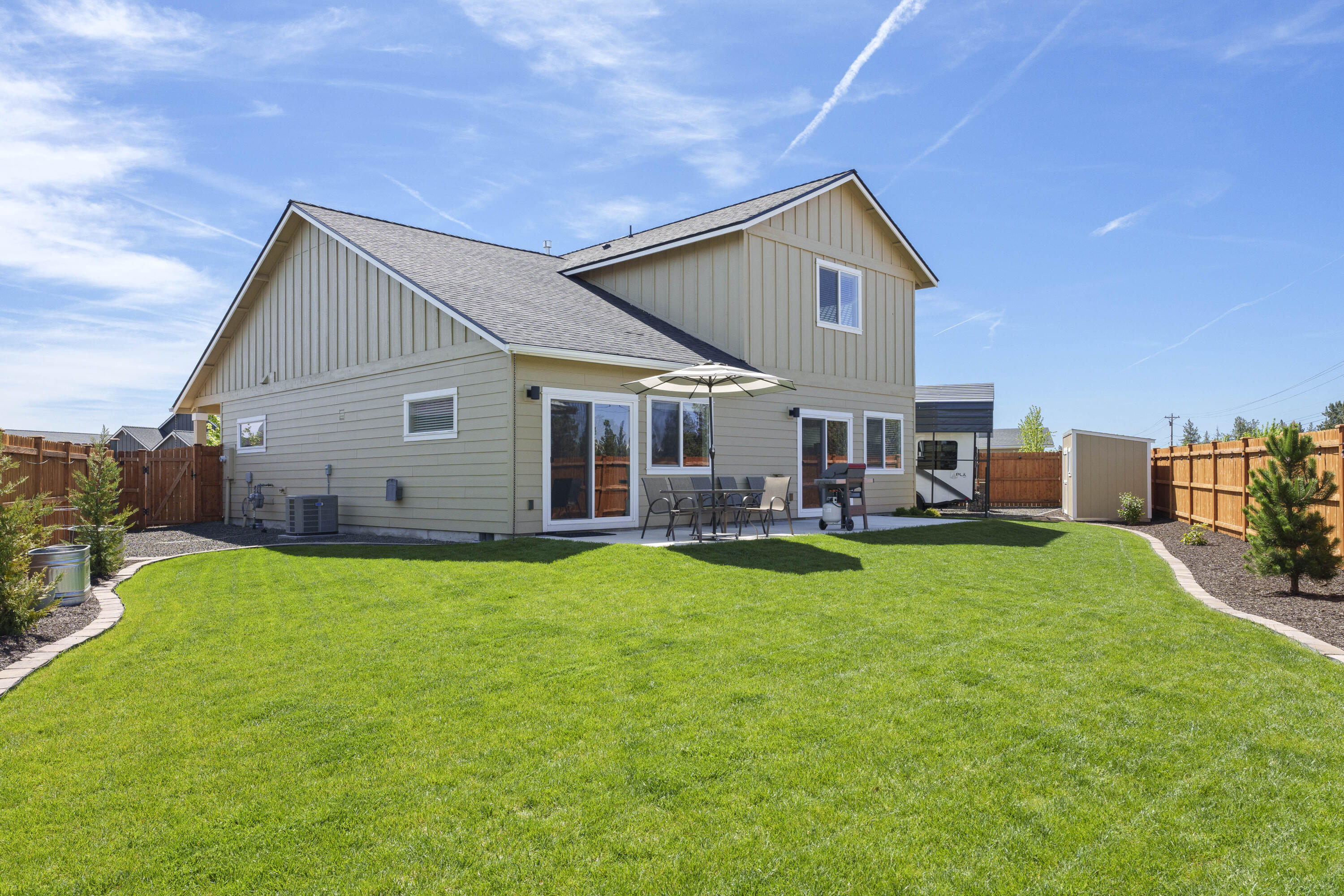 4999 Southwest Yew Place Redmond, OR 97756 - Photo 36 of 50 a view of a house with backyard porch and garden