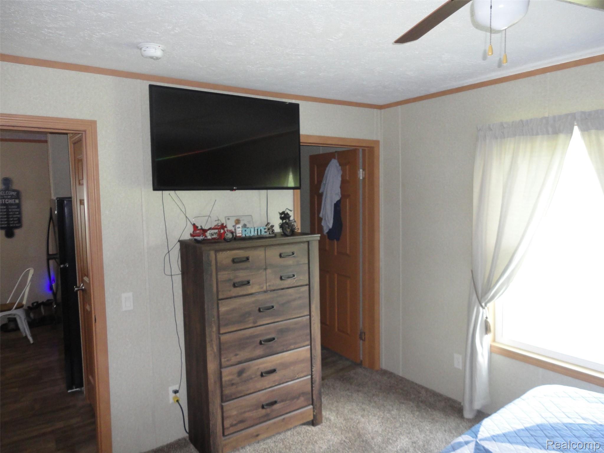 463 Edinborough Temperance, MI 48182 - Photo 8 of 23 Bedroom, Carpeted room with a ceiling fan, light wood-finish trim, and a window providing natural illumination