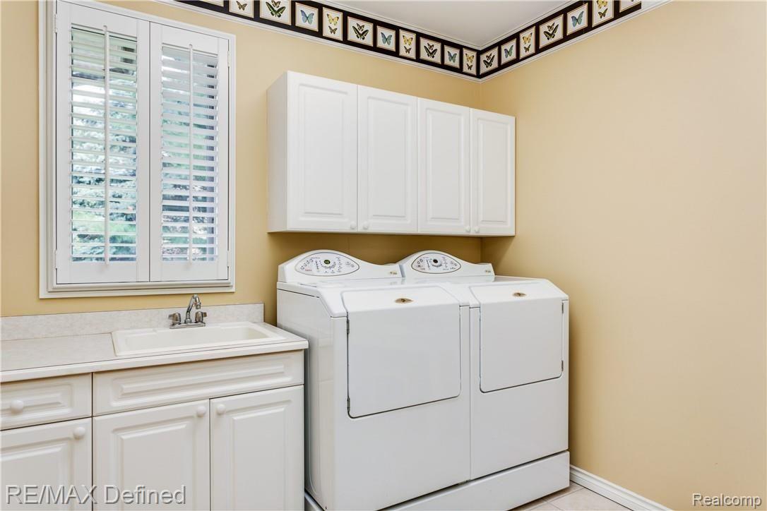 5637 Kirkridge Trail Rochester, MI 48306 - Photo 28 of 36 Light and bright first floor laundry with built-in cabinets and spacious counter.