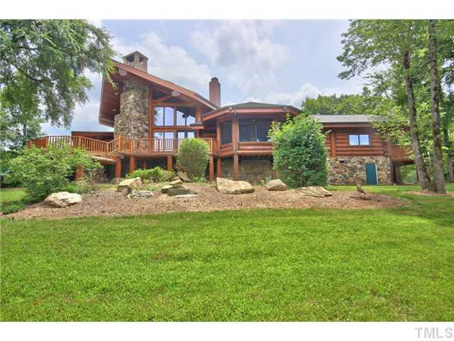 8420 Wake Forest Highway Raleigh, NC 27613 - Photo 21 of 25 Exterior back of home showcasing the stacked stone fireplace. Exterior Back