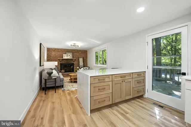 a large bedroom with a bed and wooden floor