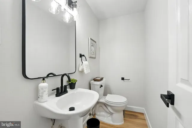 a bathroom with a sink mirror and toilet