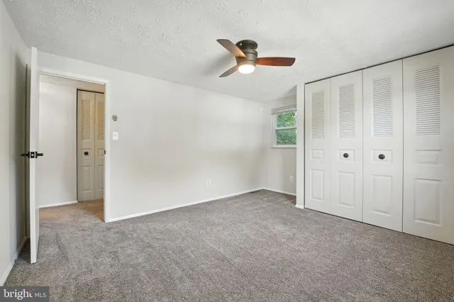a bathroom with a granite countertop sink a mirror a bathtub and shower