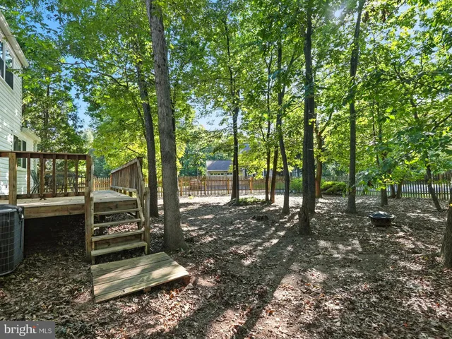 a front view of a house with yard and green space
