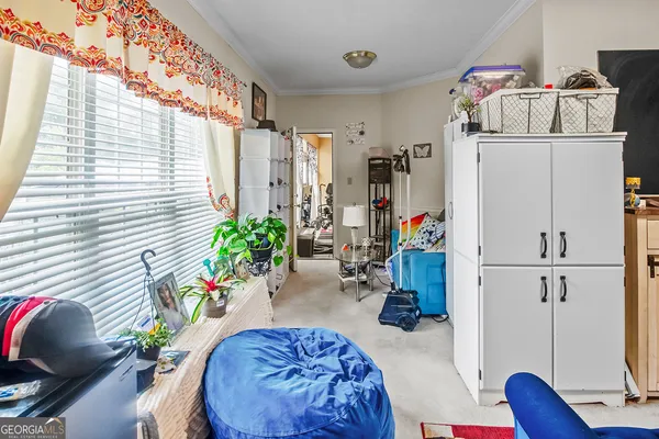 a bed sitting in a bedroom next to a window