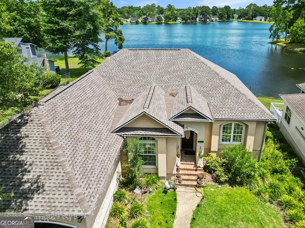 a house with garden space and lake view