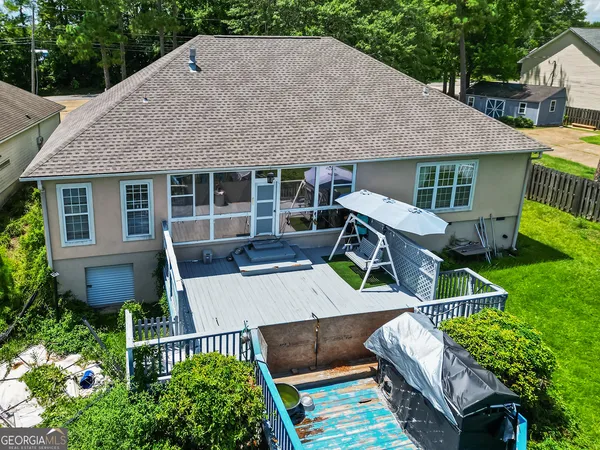 a aerial view of a house with swimming pool garden and patio