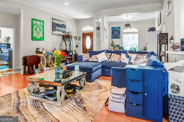 a living room with furniture a fireplace and paintings on the wall