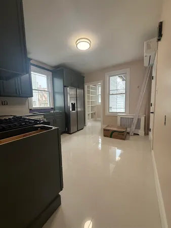 a view of a kitchen with fridge and window