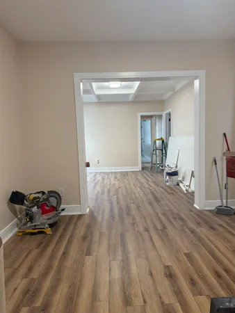 a view of a room with wooden floor and furniture