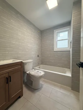 a bathroom with a toilet a sink and bathtub