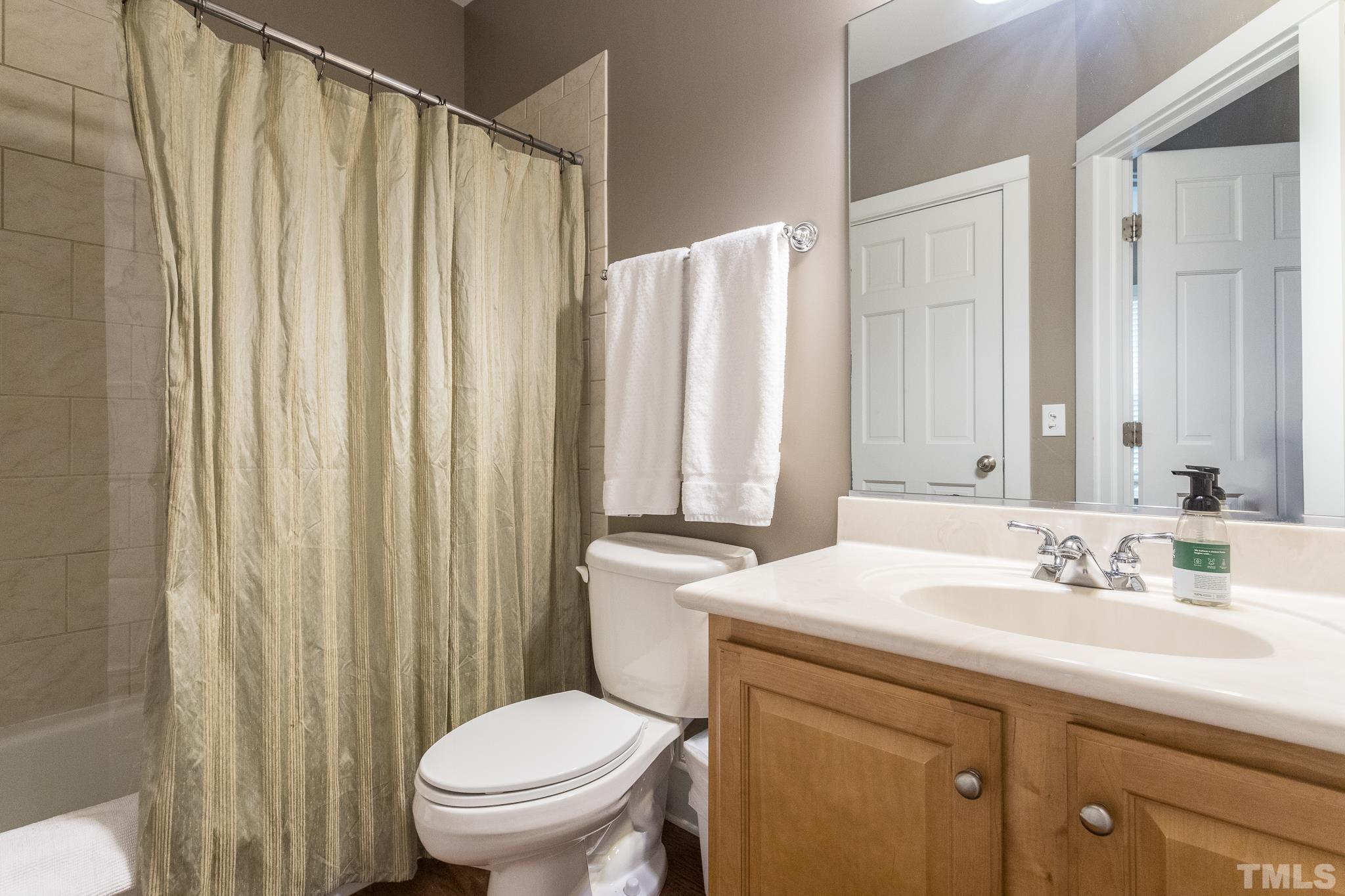 613 West Cabarrus Street, Unit 202 Raleigh, NC 27603 - Photo 13 of 25 a bathroom with a sink a toilet and a mirror