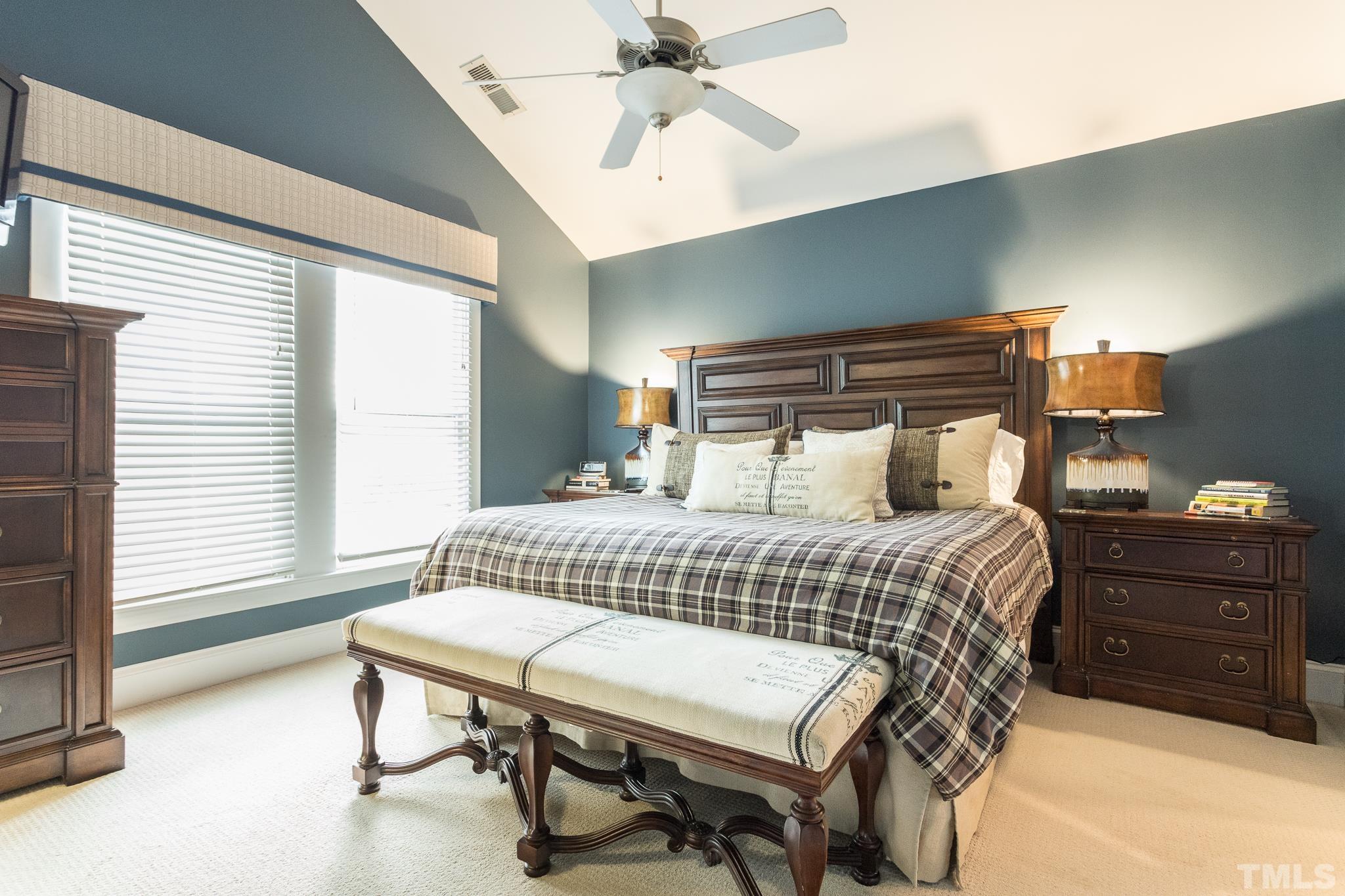 613 West Cabarrus Street, Unit 202 Raleigh, NC 27603 - Photo 16 of 25 a bedroom with a bed and a chandelier