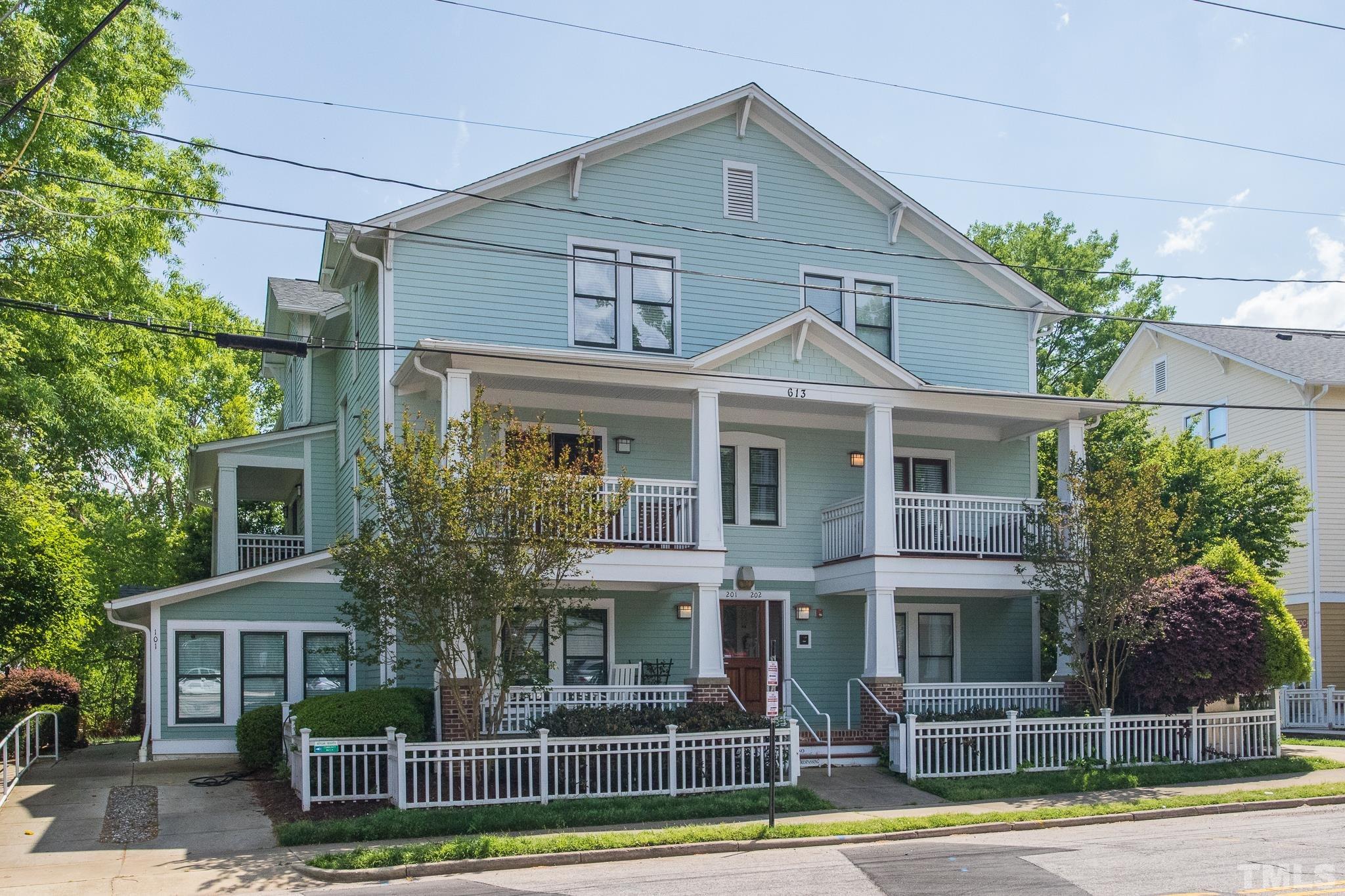 613 West Cabarrus Street, Unit 202 Raleigh, NC 27603 - Photo 2 of 25 a front view of a house with a yard and potted plants