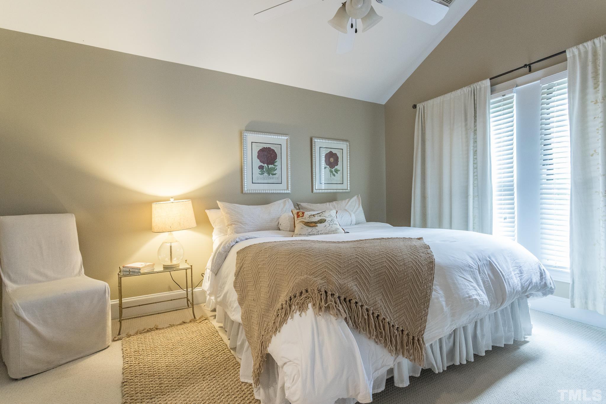 613 West Cabarrus Street, Unit 202 Raleigh, NC 27603 - Photo 21 of 25 a spacious bedroom with a bed and a couch