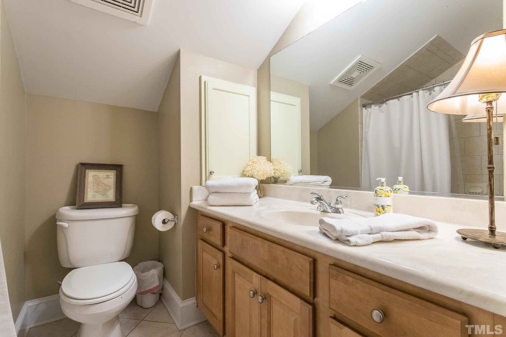 613 West Cabarrus Street, Unit 202 Raleigh, NC 27603 - Photo 23 of 25 a bathroom with a toilet sink and mirror