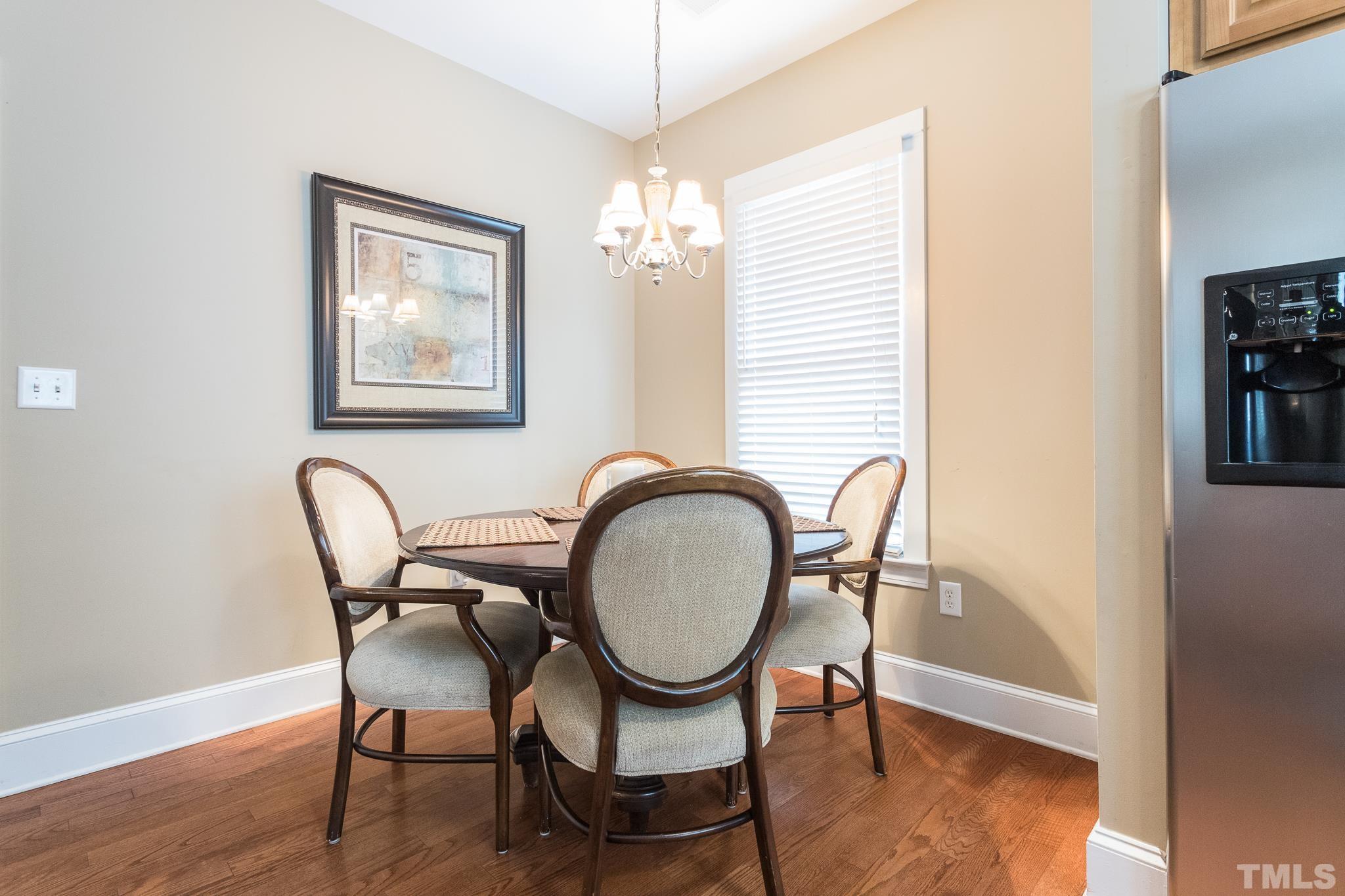 613 West Cabarrus Street, Unit 202 Raleigh, NC 27603 - Photo 4 of 25 a view of a a dining room with furniture window and wooden floor