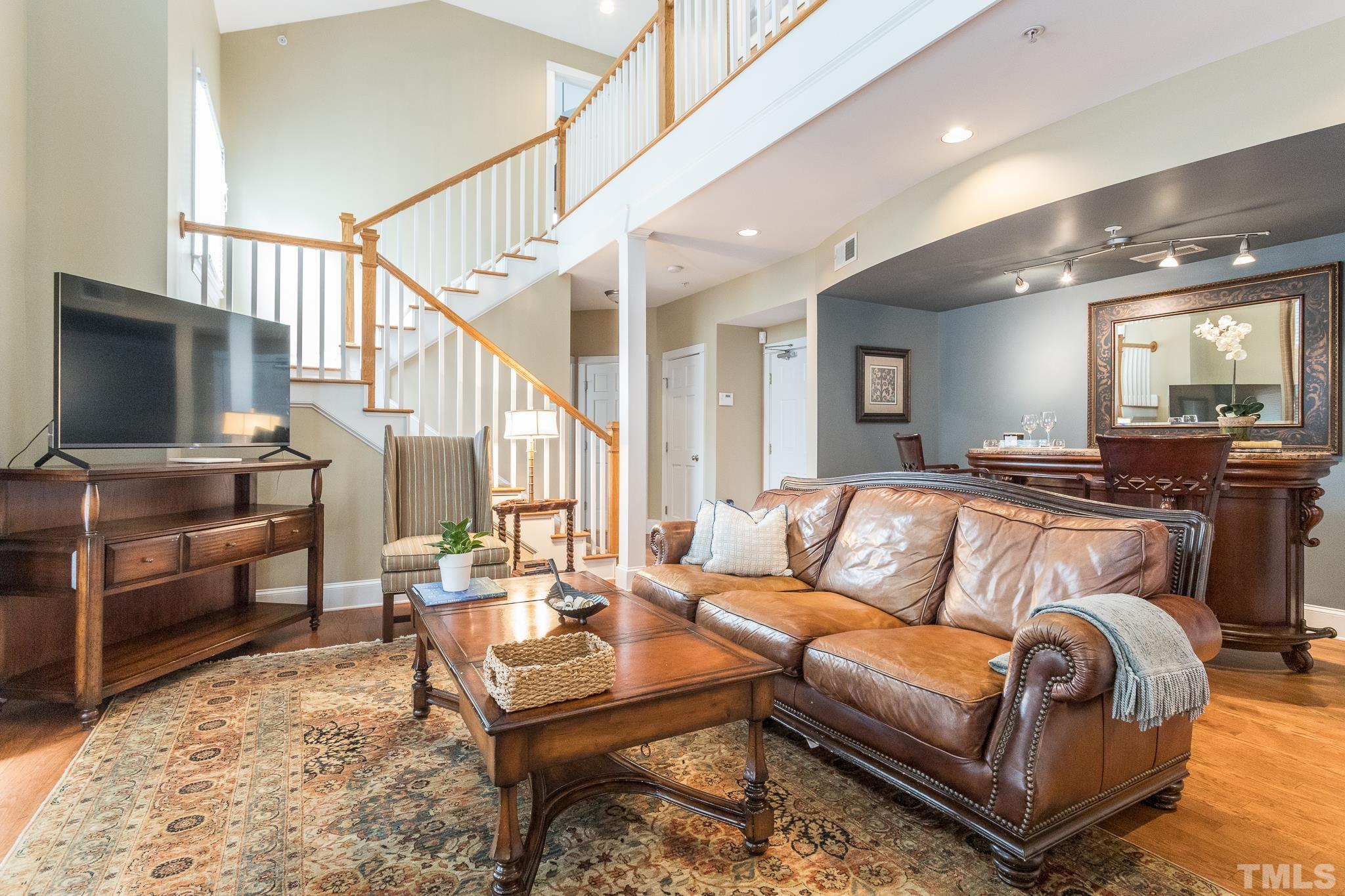 613 West Cabarrus Street, Unit 202 Raleigh, NC 27603 - Photo 6 of 25 a living room with furniture and a flat screen tv