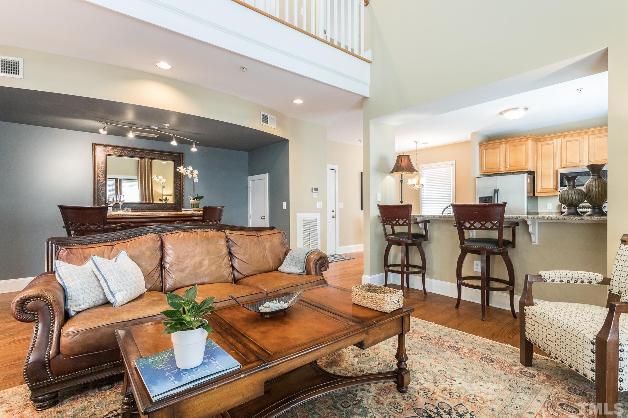 613 West Cabarrus Street, Unit 202 Raleigh, NC 27603 - Photo 7 of 25 a living room with furniture and a large window