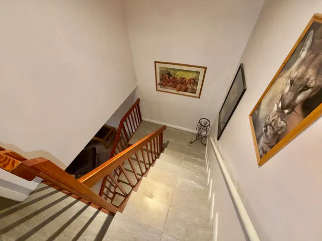 a living room with furniture a rug and a chandelier