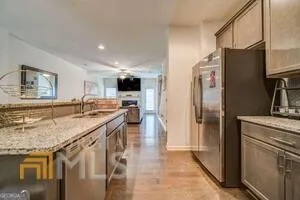 a kitchen with stainless steel appliances a refrigerator sink and stove