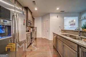 a kitchen with granite countertop a sink and a stove top oven