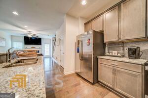 882 Ambient Way Atlanta, GA 30331 - Photo 21 of 61 a kitchen with stainless steel appliances a refrigerator sink and stove