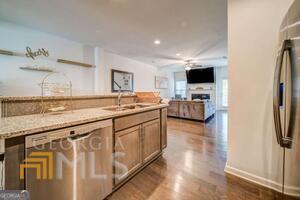 882 Ambient Way Atlanta, GA 30331 - Photo 22 of 61 a kitchen with granite countertop a sink and a stove top oven