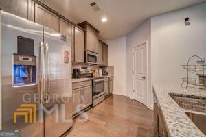882 Ambient Way Atlanta, GA 30331 - Photo 23 of 61 a kitchen with stainless steel appliances kitchen island granite countertop a refrigerator and a stove top oven