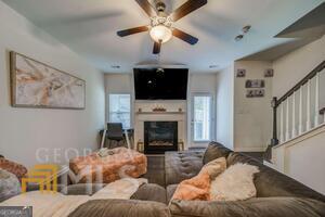 882 Ambient Way Atlanta, GA 30331 - Photo 26 of 61 a living room with furniture a fireplace and a flat screen tv