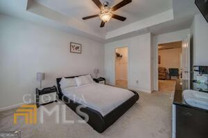 882 Ambient Way Atlanta, GA 30331 - Photo 33 of 61 a bedroom with a bed and a chandelier