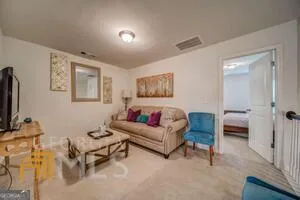 a bedroom with a bed and painting on the wall