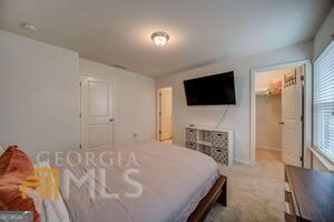 882 Ambient Way Atlanta, GA 30331 - Photo 38 of 61 a bedroom with a bed and a flat screen tv