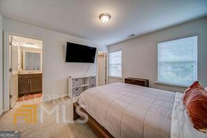 882 Ambient Way Atlanta, GA 30331 - Photo 39 of 61 a bedroom with a bed and a flat screen tv